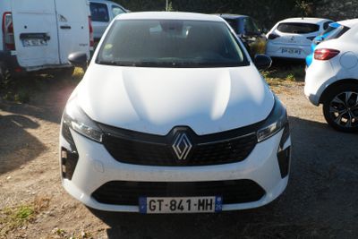 a white car parked in a parking lot with other cars
