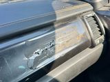 the interior of a car with a bullet hole in the dash