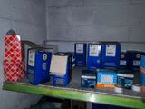 many boxes and boxes on a shelf in a room