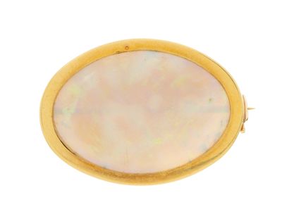 a close up of a gold and mother of pearl broochle