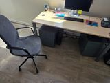 a desk with a chair and a computer on it