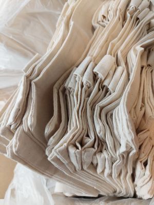 a pile of folded cloth sitting on top of a table