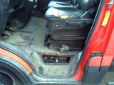 a suitcase sitting in the back seat of a red truck