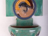 a ceramic cross with a picture of a cat on it