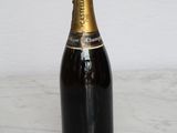a bottle of champagne sitting on a marble table