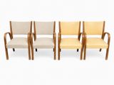 a set of four chairs in the style of person