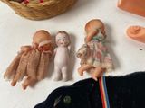 three dolls sitting next to each other on a table