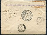 an old envelope with stamps on it sitting on top of a wooden table