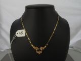 an image of a necklace on a mannequin with a price tag