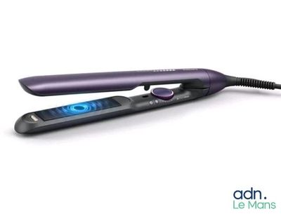 a close up of a flat iron on a white surface
