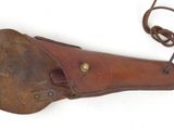 a close up of a brown leather holster with a leather strap