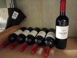 bottles of wine are lined up on a shelf in a wine cellar