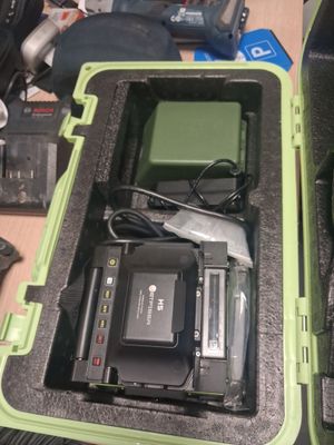 a green case with a camera and other electronics in it