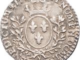 a close up of a coin with a crown on it