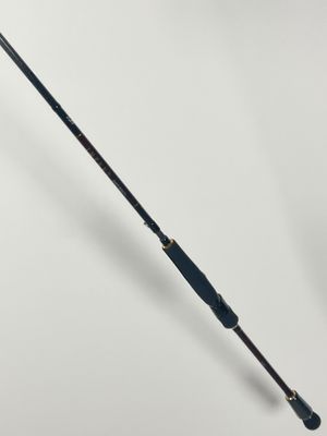 a close up of a fishing rod on a white surface