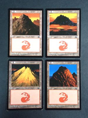 four cards with different images of mountains on them on a table