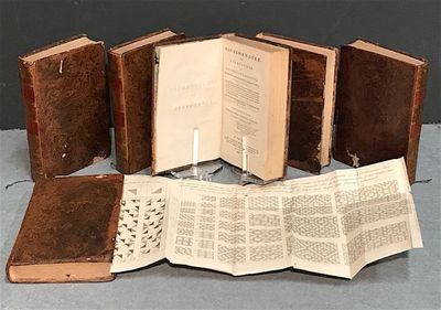 five open books sitting on a table next to each other