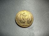 a close up of a gold coin on a table