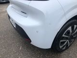 the rear end of a white car parked in a parking lot