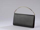 a black purse with a gold handle on a white background