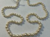 pearl necklace and bracelet set on a white surface