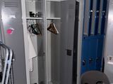 two lockers in a room with a table and chairs