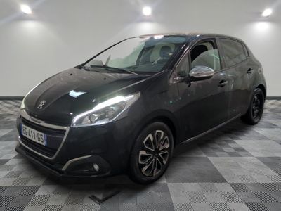 the black car is parked on a checkered floor in the garage