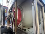 a truck with a hose attached to the back of it