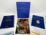 several books are sitting on a white surface with blue covers