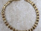 a gold plated bracelet with square links and a clasp