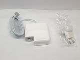 an apple power adapter and charger sitting on top of a white table