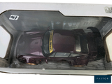 a toy car in a box with a sticker on it
