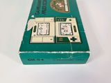 a green box with a game on it on a white surface