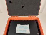 an orange and black case with a note inside of it