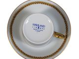an image of a cup and saucer with a gold rim