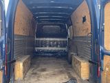 the back end of a van with the doors open and a bunch of boxes in the back of the van