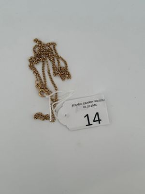 a close up of a gold chain with a tag on it