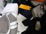 a pile of clothes and other items in a white bag