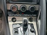 the interior of a car with a steering control and dashboard controls
