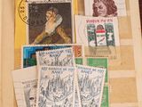 an open book with stamps on it and a picture of a woman