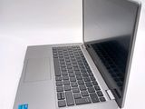 a silver laptop with a blue sticker on it