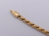 an image of a gold colored pen on a white surface