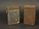 two old tins sitting next to each other on a table