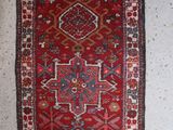 a red rug with a blue and red design on it