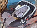 a baby car seat in a plastic bag on a pallet