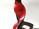 a red and black lamp with a black shade on it