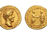 a gold coin with a bust of a man and a woman on it
