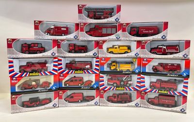 a lot of red and yellow toy fire trucks in the box