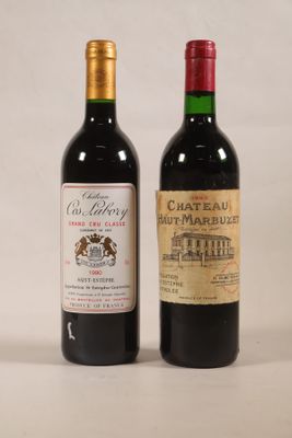 deux bouteilles de vin posées l'une à côté de l'autre sur une table