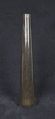 a glass vase that is sitting on a black surface